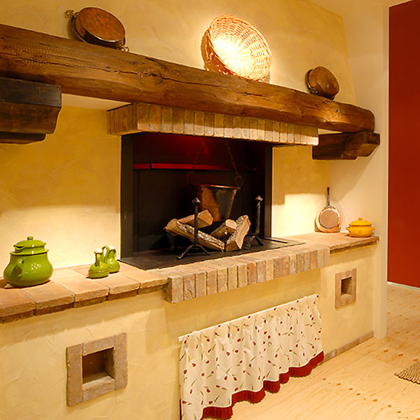 Erica, camino rustico per cucinare realizzato in legno e muratura da Caminetti Carfagna